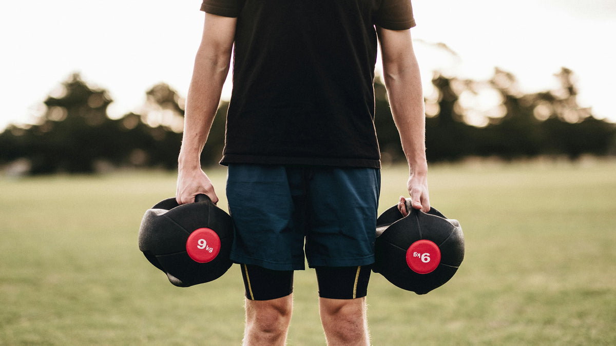 Person holding weights in hand