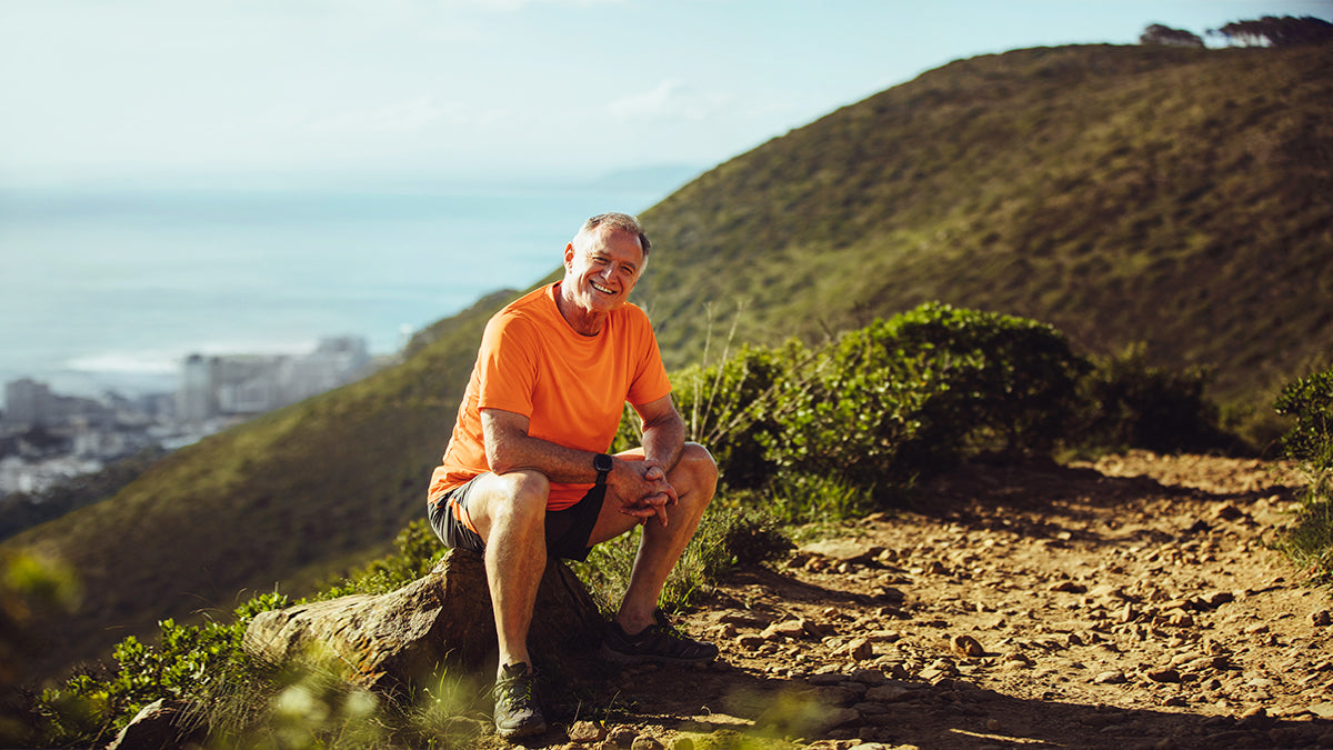 Man sitting on mountain smiling