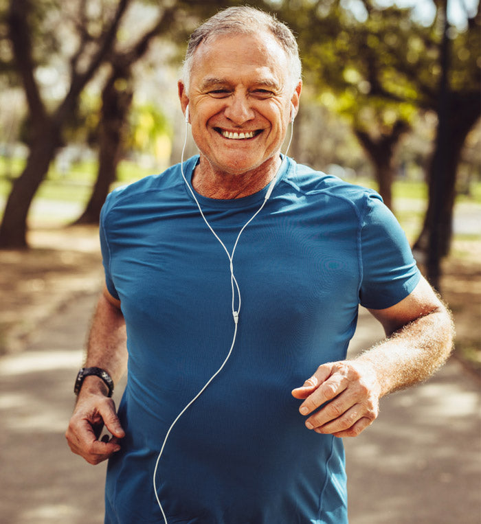 male running with headphones in