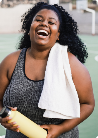 woman laughing with water bottle in hand